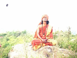 At Pavalakundru Tiruvannamalai - Swamiji Thiruvannamalai in the background. rock where he g~1.jpg