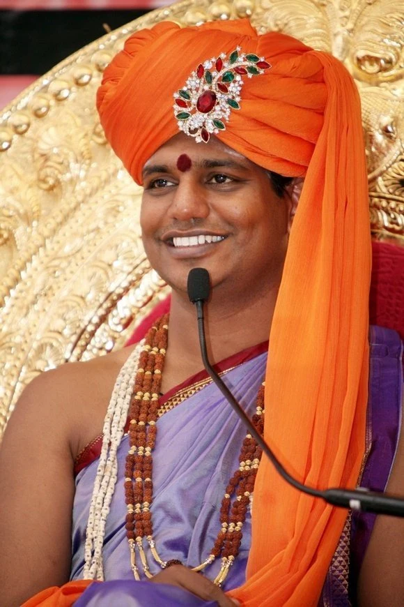 https://www.nithyananda.org/sites/default/files/photo-gallery/2011-08aug-15-nithyananda-photo-03e-nithyananda-smile_0.JPG?1313834761