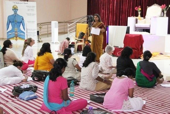 A teacher of Nithyananda order conducting a session to Inner Awakening participants