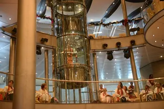Swamiji explores meditation hall on elevator.