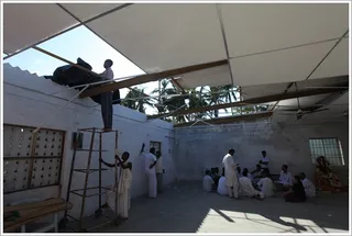 Temple at the Embalam ashram used by volunteers discussing relief activities while the Brahmacharis repair the roof that was ripped out by the cyclone.