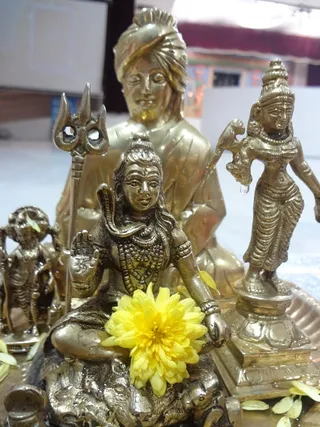 The deities being offered Puja by one of the Devotee