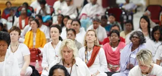 Participants perform the Kalpataru meditation process