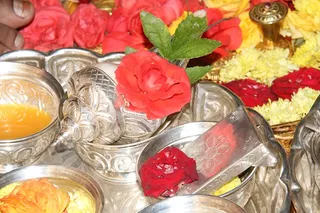The floral and other offerings being made during Padapuja