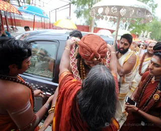 His Holiness receives the traditional flower mala offered by devotees to Deities and Divine Beings