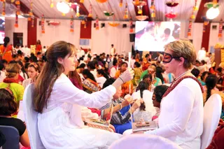 Participants pair up and help each other with their reading exercises.