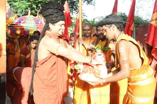Amidst music, cheering and fireworks, His Holiness lands at the spiritual headquarters in Bengaluru.