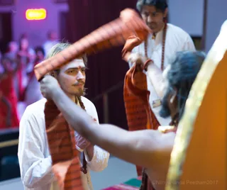 His Holiness gifts the sacred energized Kavi scarf to participants, which supports the successful completion of all processes during the program.