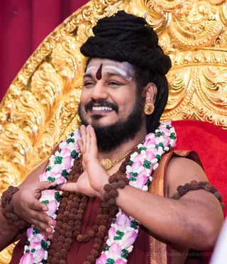 He applies the Sacred Jnananjanam, Enlightenment Eyeliner, awakening the Third Eyes of the delegates.
