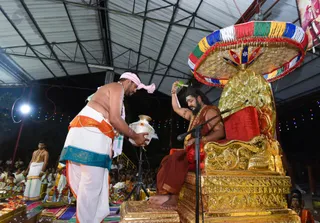 Prasada from the Kalasha Tirtha (water pot) is offered to His Holiness