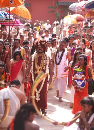 Music plays, devotees sing and dance and all the procession items are a colorful rainbow behind His Holiness!