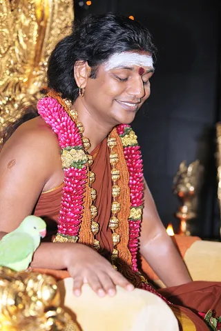 Swamiji during the Pada puja with parrot....