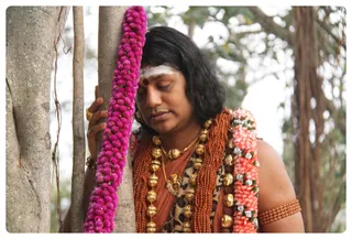 Swamiji paying respects to the Banyan Tree.