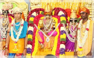 Priests enacting Devi Meenakshi and Lord Sundareswara.
