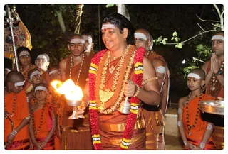 Swamiji Giving Arathi to the Sacred Banyan tree