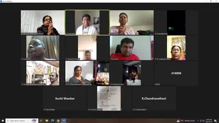 A Zoom Meeting gallery screenshot showing a grid of video tiles with participants, mostly women and a few men, many with hands pressed together in namaste. Several tiles show home settings with framed pictures, shrine-like decorations and a small deity image. A bottom-centre tile shows a printed handwritten page. Names appear on tiles, and the taskbar shows the time 10:20 AM and date 2024-05-10.