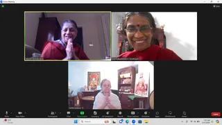 A Zoom meeting screenshot showing three participants in video tiles, with the Zoom control bar along the bottom. Top left, MED Dr Nirmala Sivaji, a smiling woman in a red robe with hands pressed in anjali namaskar. Top right, C A Shakunthaladevi Dayalingam, a smiling woman in a red sari with a red bindi, seated before a carved wooden chair and brass items. Bottom centre, martha watson, an older woman in white clothing with hands pressed together, seated in a home room with a framed painting of a deity, a wooden cabinet, a small table and a standing figure in saffron-coloured robes with a white beard, a depiction of a sage. The Zoom bar shows 3 participants and the time 7:07 AM, 5/15/2024.