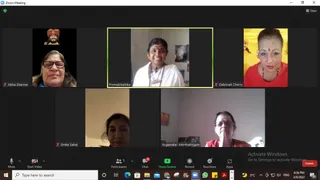 Screenshot of a Zoom video call with five participants in grid tiles. Top left, Abha Sharma, a woman with glasses, is shown beside a small inset of a bearded figure in an orange turban. Center top, Premabhaktika, a smiling woman in white clothing with a mala, stands in front of a framed picture. Top right, Deborah Cherry, a woman in a red top with a red bindi, sits before a yellow backdrop with religious imagery. Bottom row, Smita Sahai and Yogamalar Amirthalingam, a woman in glasses and red clothing with hands together, appear in their rooms. The Zoom toolbar shows a participants count of 5 and a Windows taskbar with the time 6:56 PM on 3/9/2022.