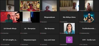 A screenshot of a video-conference gallery showing a grid of participant tiles for a global online prayer session. Most tiles show names rather than video, with a few live webcam views of people in rooms. One tile shows a woman in a red sari with a red bindi, standing before a framed image of deity murtis adorned with garlands; her tile is labelled Kailasa Los Angeles. Another live view shows a bald man in white clothing and a rudraksha-style necklace. A man in a dark robe with a turban-like head covering and a ceremonial sword-like object appears in a painted tile labelled Kailasa Los Angeles, which is a depiction. A woman in a blue patterned top with red earrings sits in front of a plain wall. Other tiles show participants' names with no video.