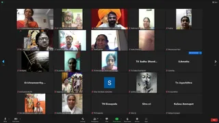 A Zoom video call grid screenshot of an online KAILASA daily update session with a 5x3 gallery of participant tiles and a bottom control bar showing Mute, Share Screen, Participants 38 and an End button. Tiles show participants in varied home settings: a man in an orange turban, a bald man in a white shirt before framed deity pictures, women in saffron and white saris, and several tiles with plain name labels or initials only. A few tiles show deity murtis or a glowing Buddha-like statue image, and one tile shows a woman before a garlanded deity picture. Participant name labels are visible under each tile. No candidate is clearly identifiable by appearance, so no a person is claimed.